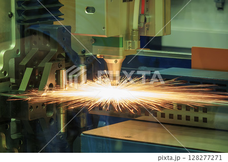 Close up scene the fiber laser cutting machine cut the metal plate control by CNC program. Close up scene the fiber laser cutting machine cut the metal plate control by CNC program. 128277271