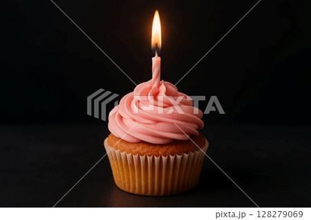 Single Cupcake with Pink Frosting and Candle on Dark Background 128279069