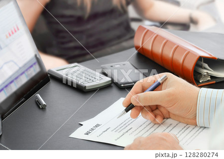 Job Interview in the office with focus on resume and pen 128280274