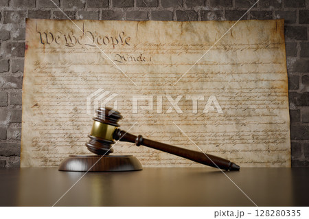 United States Constitution On Wall with Gavel Resting on Table in Front. 128280335
