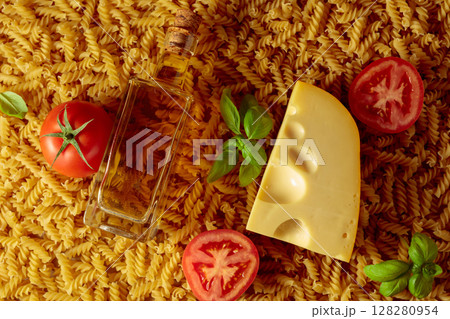 Uncooked fusilli pasta with tomatoes, olive oil, basil and cheese. Uncooked fusilli pasta with tomatoes, olive oil, basil and cheese. 128280954