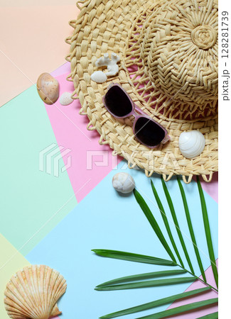 Creative minimal summer idea. Tropical beach concept made of bamboo hat, sunglasses, seashells and green palm leaves on pastel background. Creative art. Flat lay, top view. Copy space 128281739