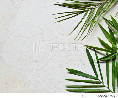 Creative minimal summer idea. Green leaf branches. Palm leaves. Tropical exotic background with empty space for text. Concept creative art. Flat lay, top view. Creative minimal summer idea. Green leaf branches. Palm leaves. Tropical exotic background with empty space for text. Concept creative art. Flat lay, top view. 128281755