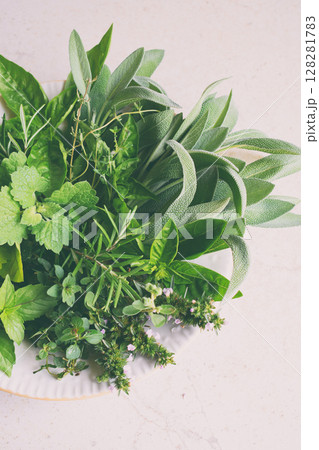 Fresh spicy and medicinal herbs on white background. Bouquet from various herb - rosemary, oregano, sage, marjoram, basil, thyme, mint. 128281783