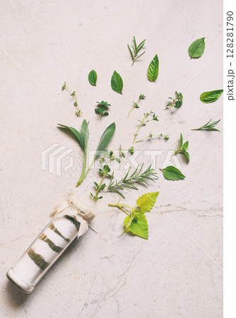 Ayurvedic herbal salt in glass jar. Sea salt with aromatic herb - rosemary, oregano, sage, marjoram, basil, thyme, mint, bay leaf. Copy space Ayurvedic herbal salt in glass jar. Sea salt with aromatic herb - rosemary, oregano, sage, marjoram, basil, thyme, mint, bay leaf. Copy space 128281790