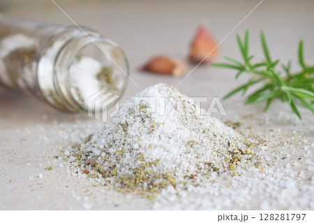 Herbal salt in glass jar. Sea salt with aromatic herb - rosemary and garlic. Copy space Herbal salt in glass jar. Sea salt with aromatic herb - rosemary and garlic. Copy space 128281797