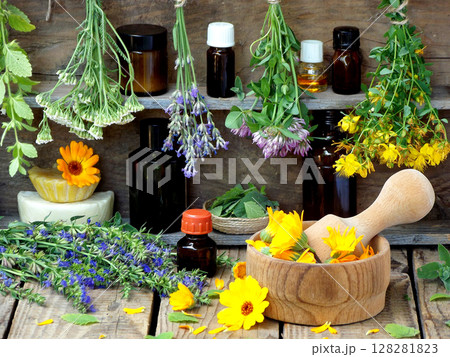 bunches of healing herbs - mint, yarrow, lavender, clover, hyssop, milfoil, mortar with flowers of calendula and bottles, herbal medicine bunches of healing herbs - mint, yarrow, lavender, clover, hyssop, milfoil, mortar with flowers of calendula and bottles, herbal medicine 128281823