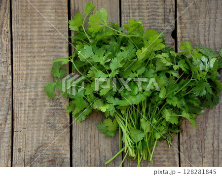 big bunch of cilantro on wooden background 128281845