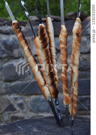 bread sticks of dough cooked on a fire. Italian breadsticks from wholemeal flour with herbs 128282000