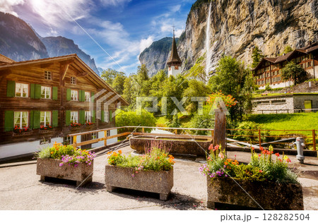 Majestic view of alpine village. Swiss alps, Lauterbrunnen valley, Staubbach waterfall, Europe. Majestic view of alpine village. Swiss alps, Lauterbrunnen valley, Staubbach waterfall, Europe. 128282504