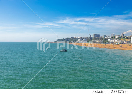 Wide Coastal View of Folkestone Beach, Turquoise English Channel and Fishing Boat, Kent UK 128282552