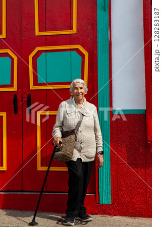 Senior woman at the beautiful colonial town of Concepcion located in the department of Antioquia in Colombia. Senior woman at the beautiful colonial town of Concepcion located in the department of Antioquia in Colombia. 128283187