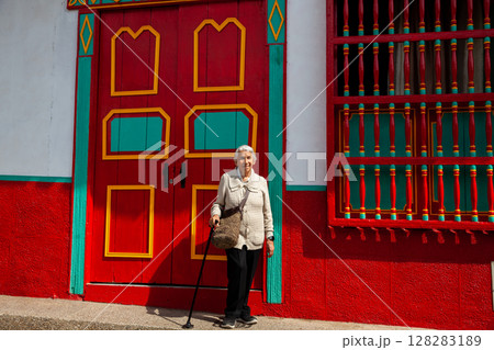 Senior woman at the beautiful colonial town of Concepcion located in the department of Antioquia in Colombia. Senior woman at the beautiful colonial town of Concepcion located in the department of Antioquia in Colombia. 128283189
