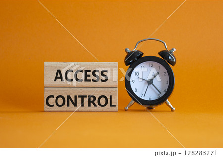 Access Control symbol. Concept words Access Control on wooden blocks. Beautiful orange background with alarm clock. Business and Access Control concept. Copy space. 128283271