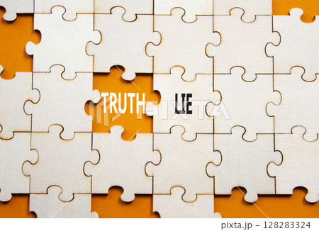Truth or Lie symbol. Concept word Truth or Lie on wooden puzzle. Beautiful orange background. Business and Truth or Lie concept. Copy space 128283324