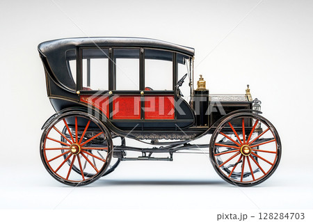 Antique carriage with red accents on a white background emphasizing its retro design details 128284703