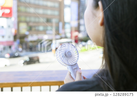 ハンディファンを使う女性 128289175