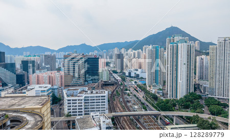 July 6 2025 Urban Train Tracks Amid Modern Skyscrapers and Busy City Streets 128289779
