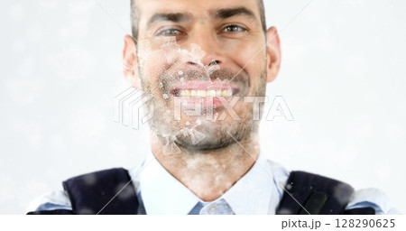 Image of macro Covid-19 cells floating over Caucasian man looking at the camera and smiling 128290625