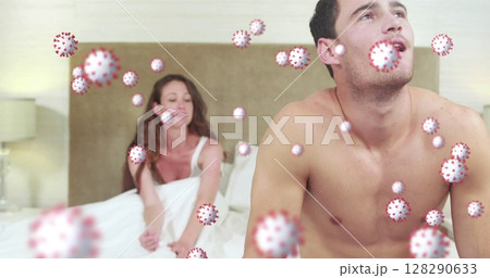 Image of cells floating over caucasian couple sitting on bed having a fight 128290633