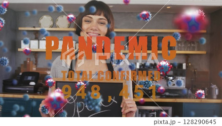 Image of cells floating over happy caucasian female chef holding open sign in restaurant Image of cells floating over happy caucasian female chef holding open sign in restaurant 128290645