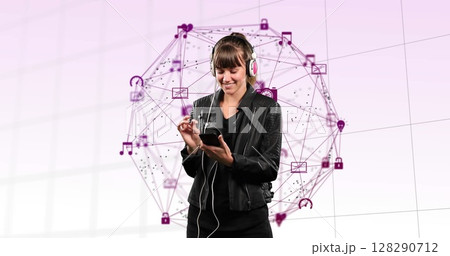 Young woman using smartphone with headphones, surrounded by digital interface icons 128290712