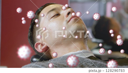 Lying back, man surrounded by digital coronavirus graphics illustrating health concept Lying back, man surrounded by digital coronavirus graphics illustrating health concept 128290783