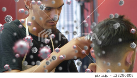 Barber cutting hair while surrounded by virus particles, focusing on precision 128290809