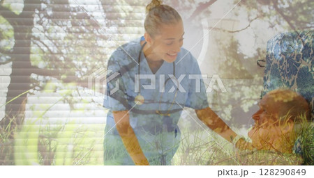 Image of grass on a windy field over nurse checking on her senior male patient at the hospital 128290849