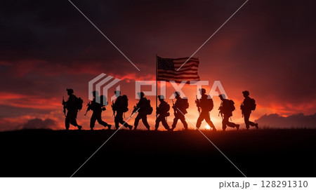 Veterans day celebrations honoring the sacrifices of heroes at sunset with American flag and silhouettes of soldiers 128291310
