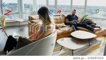 Image of letters flying over man and woman using electronic devices at home Image of letters flying over man and woman using electronic devices at home 128291520