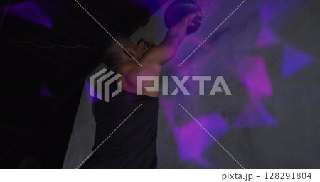 Image of colourful shapes over man exercising with a ball 128291804