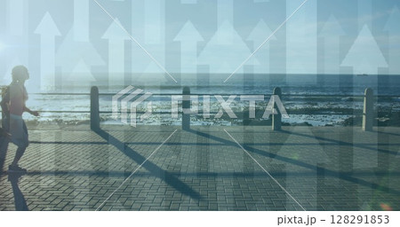 Multiple arrow moving upwards against african american woman running on the promenade Multiple arrow moving upwards against african american woman running on the promenade 128291853