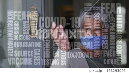 Covid-19 text concept text against african american senior woman wearing face mask opening the door 128293093