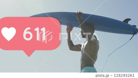 Image of speech bubble with heart icon and numbers over man carrying surfboard on beach 128293261