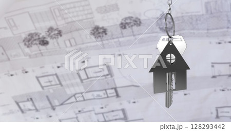 Keychain in house shape hanging over blueprints, symbolizing new home ownership 128293442
