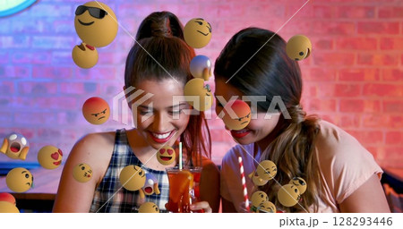 Friends enjoying drinks at cafe, surrounded by playful emoji graphics 128293446