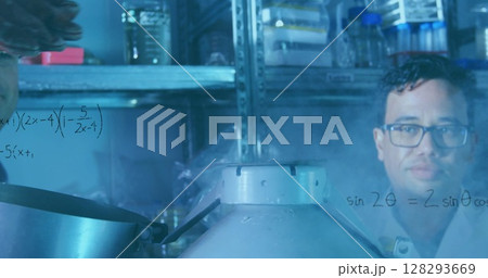 Scientist analyzing data on glass in laboratory with scientific equipment Scientist analyzing data on glass in laboratory with scientific equipment 128293669