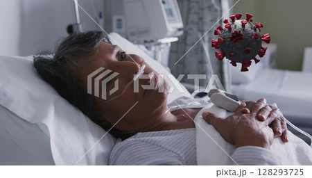 Hospital patient resting in bed with oxygen support, coronavirus illustration nearby 128293725