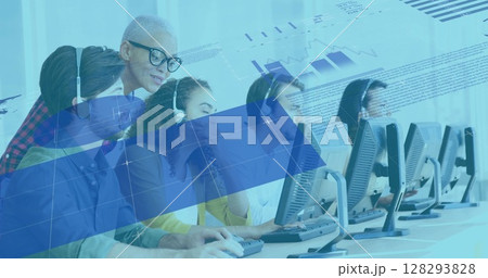 Diverse team collaborating on computers, analyzing digital data in modern office 128293828