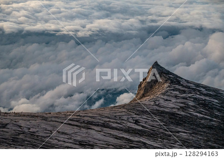 Scenery view of an iconic peak named South Peak on Mt.Kinabalu, Malaysia before sunrise. Mount Kinabalu is the tallest mountain in Malaysia and Borneo. 128294163