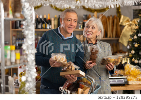 Elderly spouses choose consider nougat, panettone, marzipan, cookies, chocolate 128295275