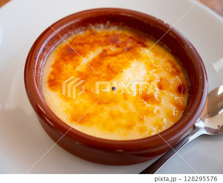 Catalan cream delicious dessert with sugar toast closeup. Typical in Catalonia Spain Catalan cream delicious dessert with sugar toast closeup. Typical in Catalonia Spain 128295576