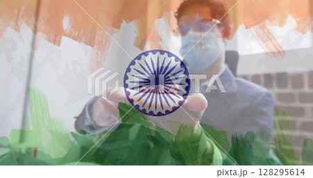 Composition of businessman wearing face mask disinfecting his hands in office over indian flag Composition of businessman wearing face mask disinfecting his hands in office over indian flag 128295614