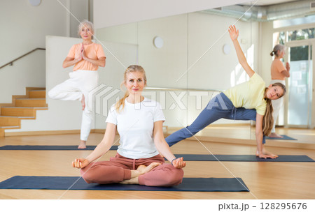 Continuity of generations - family in lotus position doing yoga in gym 128295676