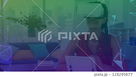 Image of networks of connections over woman wearing vr headset in background 128295677