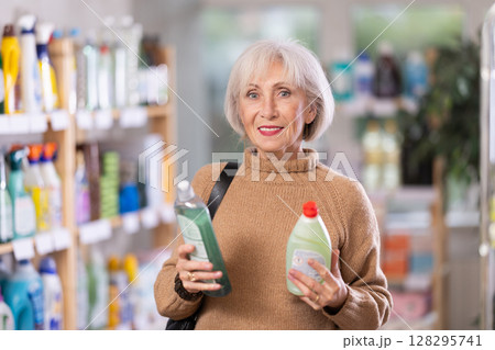 Mature woman choosing dishwashing detergents Mature woman choosing dishwashing detergents 128295741