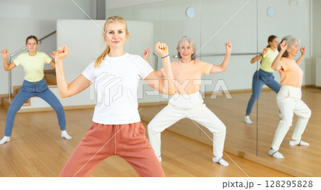 Women enjoying active dances in modern dance studio 128295828