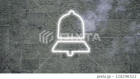 Neon bell sign glowing on textured stone wall, creating modern urban vibe 128296322