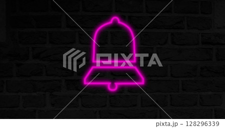 Neon pink bell glowing against dark brick wall, creating vibrant contrast 128296339